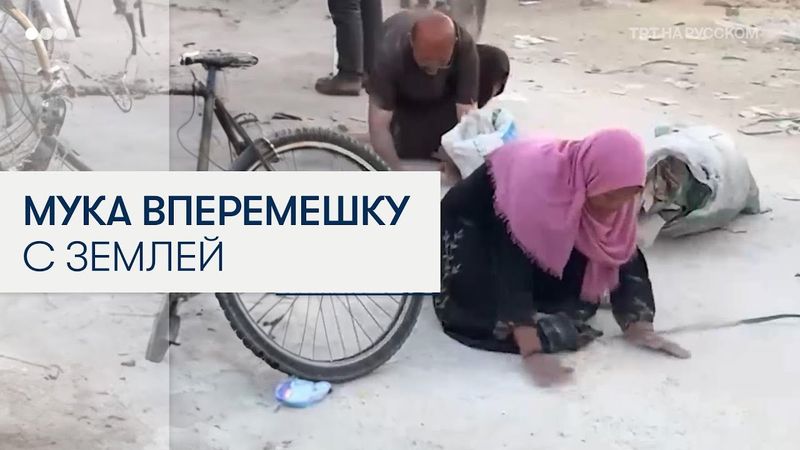 Палестинка в отчаянии собирает муку с земли в Газе
