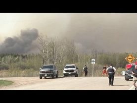 Police say two people were killed in massive wildfire in central Canadian province of Manitoba