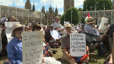 Demonstrators hold up placards in support of Palestine Action in central London | AFP