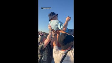 Heartwarming moment Oasis fans band together to lift disabled fan in the air