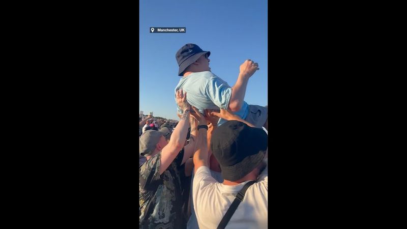 Heartwarming moment Oasis fans band together to lift disabled fan in the air