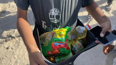 Gazans carry food aid from new distribution centre in Rafah | AFP